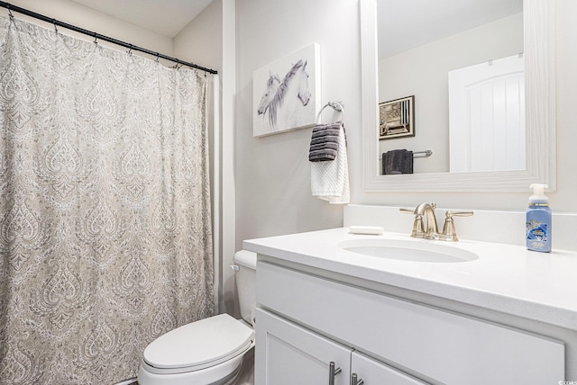 full bathroom with toilet and vanity