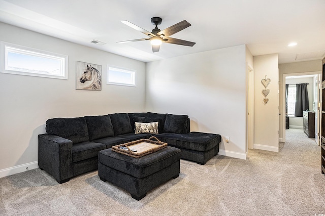 living room with light colored carpet, a ceiling fan, and baseboards