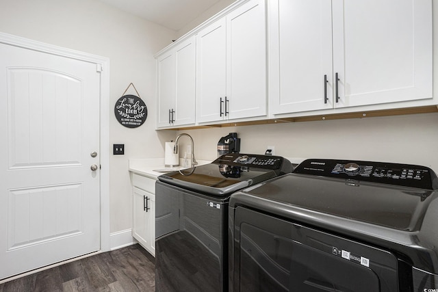 laundry area with dark wood-style floors, independent washer and dryer, cabinet space, and baseboards