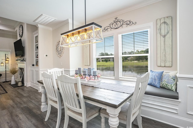 dining room with crown molding, dark wood-type flooring, and a chandelier