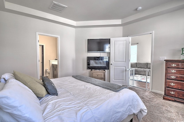 bedroom featuring carpet flooring, baseboards, and ensuite bathroom