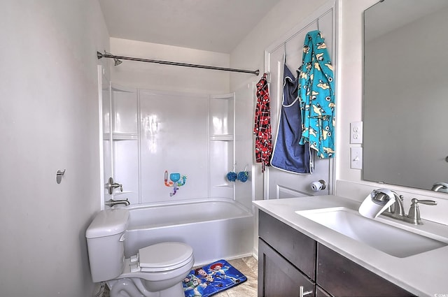 bathroom featuring toilet, vanity, and shower / bathtub combination