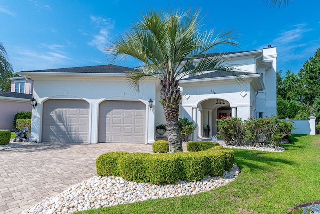 616 Edgecreek Dr, Myrtle Beach, SC 29579 - view of front of property featuring a garage, a chimney, a front lawn, decorative driveway, and stucco siding