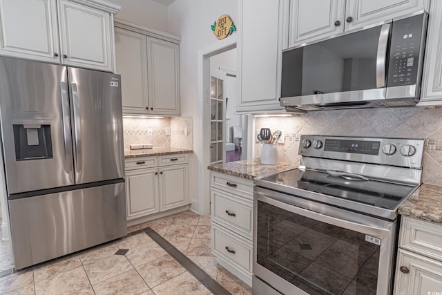 616 Edgecreek Dr, Myrtle Beach, SC 29579 - kitchen featuring stainless steel appliances, tasteful backsplash, inlaid floor details, and light stone counters