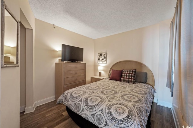 1501 Ocean Blvd S Unit 103, North Myrtle Beach, SC 29582 - bedroom featuring dark wood finished floors, a textured ceiling, and baseboards