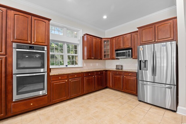 423 Chapman Loop, Pawleys Island, SC 29585 - kitchen featuring stainless steel appliances, light stone countertops, glass insert cabinets, decorative backsplash, and ornamental molding
