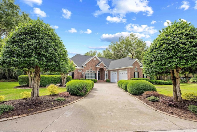 423 Chapman Loop, Pawleys Island, SC 29585 - traditional-style home with brick siding, an attached garage, driveway, and a front lawn