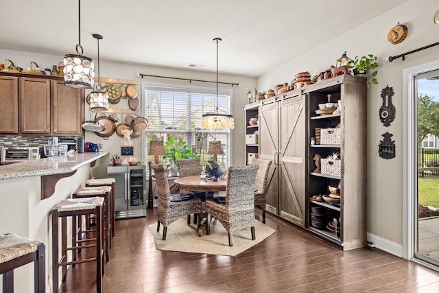 1189 Wyatt Ln, Myrtle Beach, SC 29577 - dining room with dark wood-style flooring, beverage cooler, and baseboards