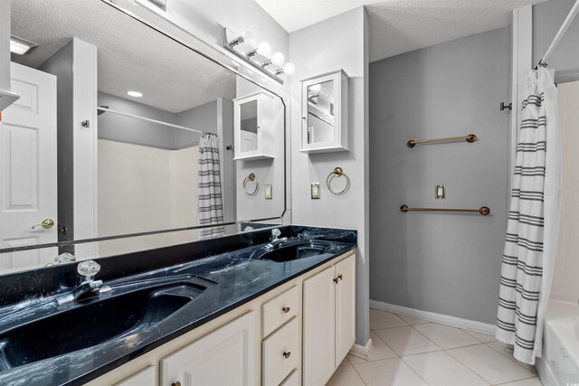 4406 Barcelona Ln, Little River, SC 29566 - bathroom featuring double vanity, a textured ceiling, tile patterned floors, baseboards, and shower / bathtub combination with curtain