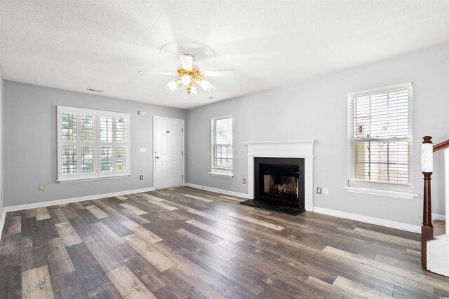 4406 Barcelona Ln, Little River, SC 29566 - unfurnished living room featuring plenty of natural light, wood finished floors, ceiling fan, and a fireplace