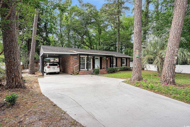 1205 King St, Myrtle Beach, SC 29577 - single story home with concrete driveway, brick siding, a porch, and a carport