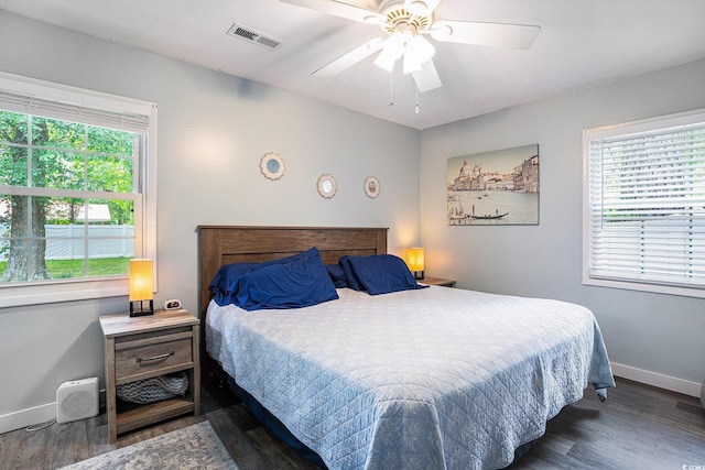 1205 King St, Myrtle Beach, SC 29577 - bedroom with baseboards, multiple windows, and wood finished floors