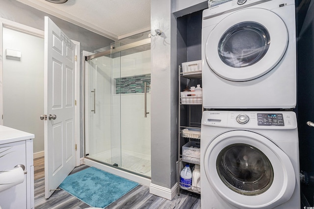 1205 King St, Myrtle Beach, SC 29577 - bathroom with estacked washer and dryer, wood finished floors, a stall shower, and baseboards