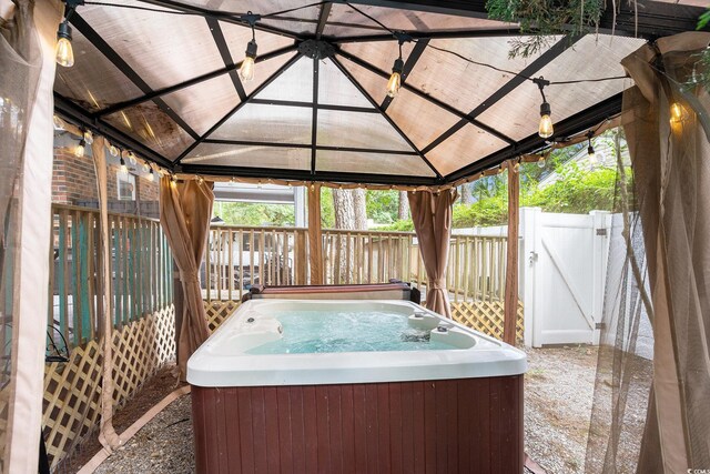 1205 King St, Myrtle Beach, SC 29577 - view of patio with a hot tub, a gazebo, and a gate