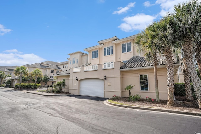 2180 Waterview Dr Unit 725, North Myrtle Beach, SC 29582 - multi unit property featuring asphalt driveway, a tile roof, a garage, stucco siding, and a residential view