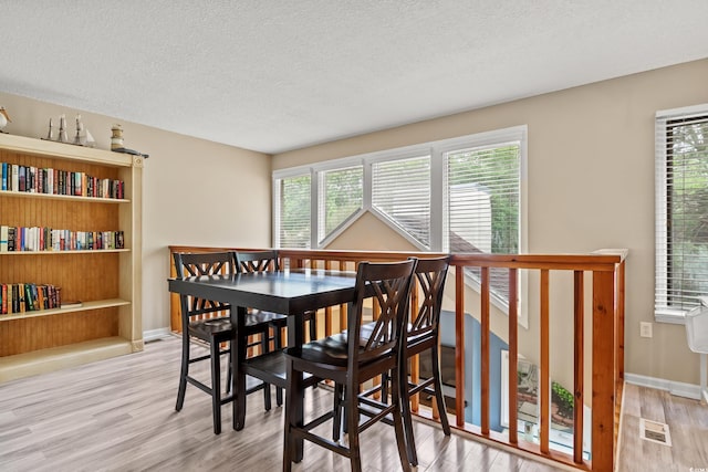 430 Ocean Creek Dr Unit 2534, Myrtle Beach, SC 29572 - dining room featuring a textured ceiling, wood finished floors, and baseboards
