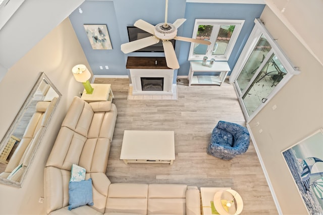 430 Ocean Creek Dr Unit 2534, Myrtle Beach, SC 29572 - living room featuring a ceiling fan, wood finished floors, baseboards, and a glass covered fireplace