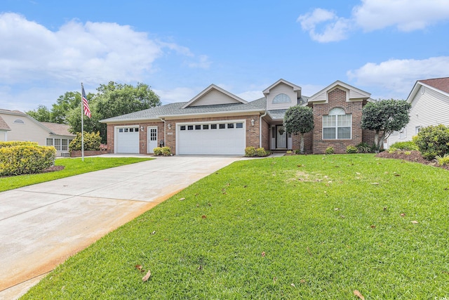 2479 Glen Dr, Little River, SC 29566 - view of front of home featuring driveway, a garage, a front yard, and brick siding