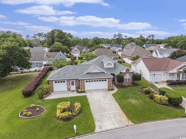 2479 Glen Dr, Little River, SC 29566 - view of front of property with brick siding, a front yard, and concrete driveway