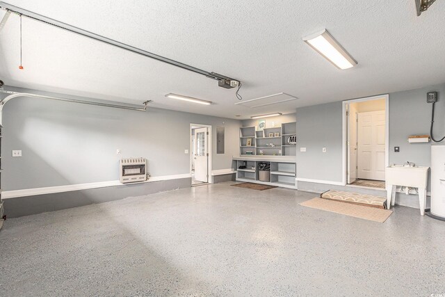 2479 Glen Dr, Little River, SC 29566 - garage with heating unit, a garage door opener, electric panel, and baseboards