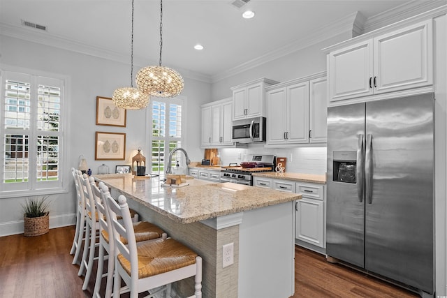 1106 Tarpon Pond Rd, North Myrtle Beach, SC 29582 - kitchen featuring appliances with stainless steel finishes, dark wood-type flooring, white cabinetry, a center island with sink, and recessed lighting