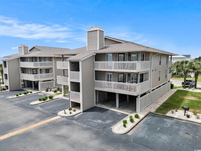 1801 N Ocean Blvd Unit Q-2, North Myrtle Beach, SC 29582 - view of apartment building / complex featuring uncovered parking