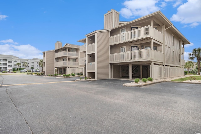 1801 N Ocean Blvd Unit Q-2, North Myrtle Beach, SC 29582 - view of building exterior with uncovered parking