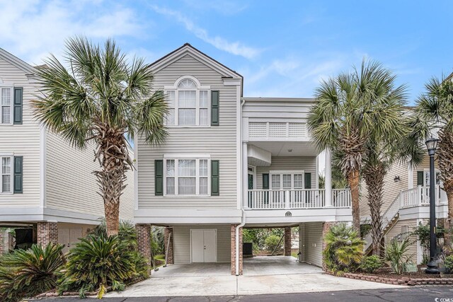 212 Millwood Dr, Surfside Beach, SC 29575 - coastal inspired home with a carport, driveway, and a balcony
