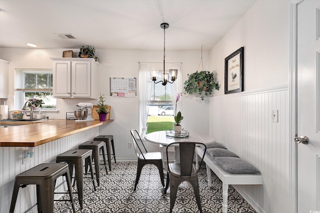 1209 Eagle Creek Dr, Myrtle Beach, SC 29588 - dining space featuring healthy amount of natural light, a chandelier, and a wainscoted wall