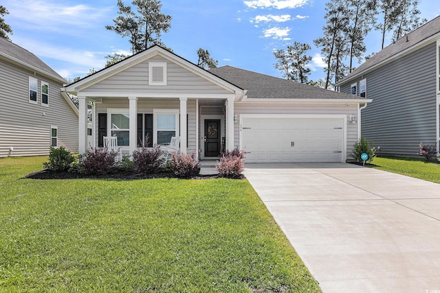 179 Empyrean Cir, Myrtle Beach, SC 29588 - view of front facade with a garage, a front lawn, driveway, and covered porch