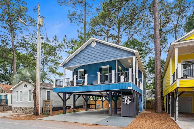 6001-1737 S Kings Hwy, Myrtle Beach, SC 29575 - view of front of home with a carport, concrete driveway, and a porch