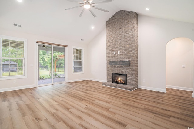 1476 Burriss Rd, Conway, SC 29526 - unfurnished living room featuring ceiling fan, arched walkways, high vaulted ceiling, a fireplace, and light wood-style flooring
