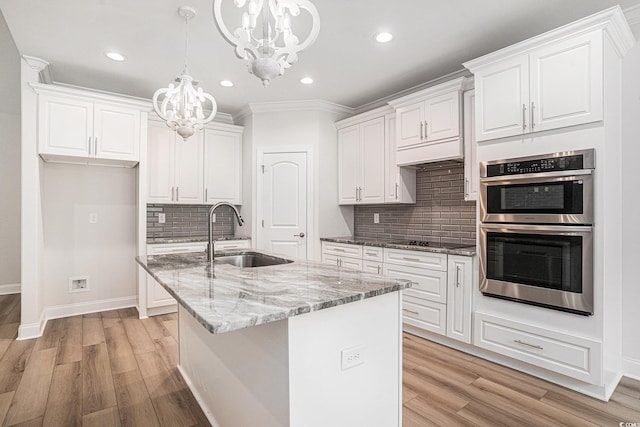 1476 Burriss Rd, Conway, SC 29526 - kitchen with a sink, double oven, a chandelier, black electric cooktop, and white cabinets