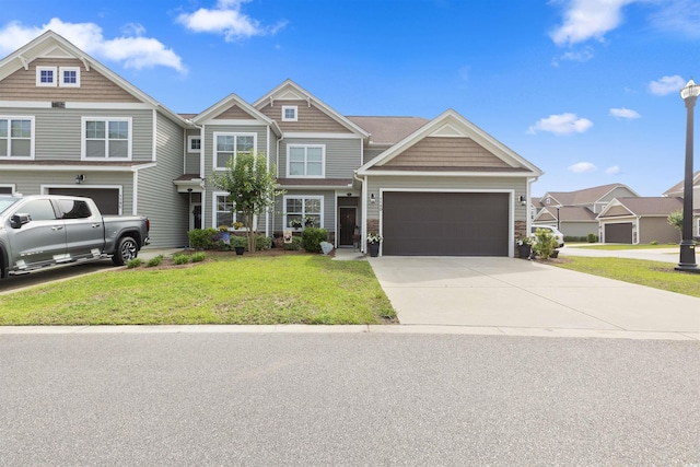115 Machrie Loop Unit D, Myrtle Beach, SC 29588 - view of front of house featuring a front lawn, an attached garage, concrete driveway, and stone siding