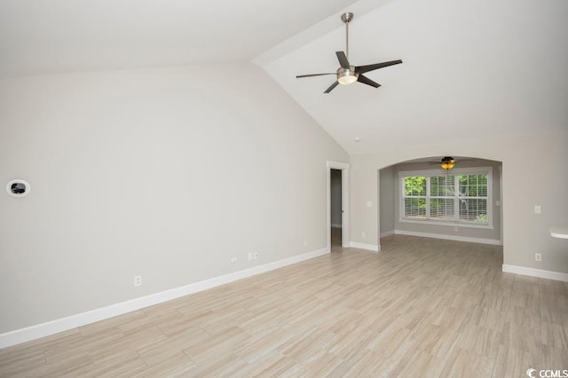 231 Marbella Dr, Murrells Inlet, SC 29576 - unfurnished living room featuring a ceiling fan, high vaulted ceiling, arched walkways, baseboards, and light wood-type flooring