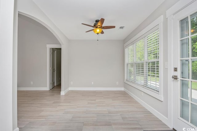 231 Marbella Dr, Murrells Inlet, SC 29576 - spare room featuring healthy amount of natural light, arched walkways, a ceiling fan, and baseboards