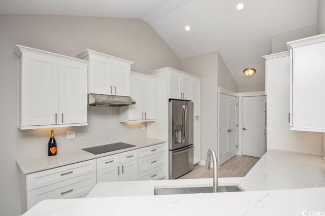 231 Marbella Dr, Murrells Inlet, SC 29576 - kitchen featuring stainless steel refrigerator with ice dispenser, under cabinet range hood, lofted ceiling, a sink, and black electric cooktop