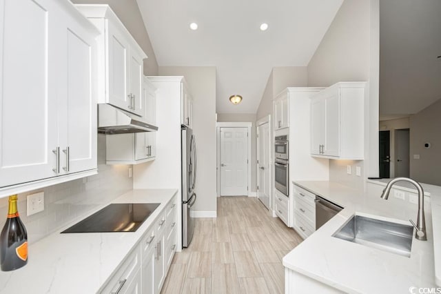 231 Marbella Dr, Murrells Inlet, SC 29576 - kitchen with under cabinet range hood, stainless steel appliances, a sink, lofted ceiling, and white cabinets