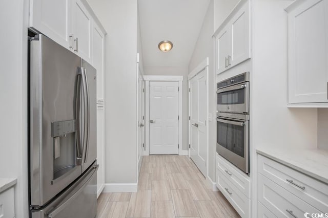 231 Marbella Dr, Murrells Inlet, SC 29576 - kitchen featuring appliances with stainless steel finishes, baseboards, white cabinetry, and light stone countertops
