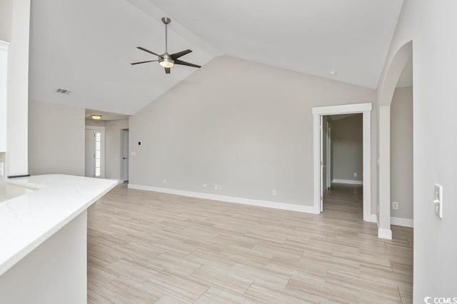 231 Marbella Dr, Murrells Inlet, SC 29576 - unfurnished living room with a ceiling fan, arched walkways, baseboards, light wood finished floors, and high vaulted ceiling