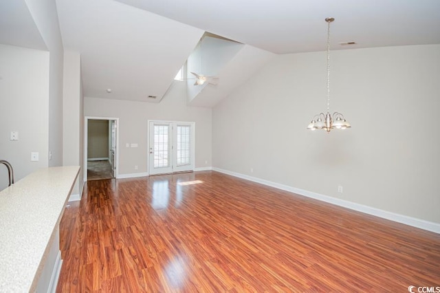 908 Wrigley Dr Unit 17-317-3G, Myrtle Beach, SC 29588 - unfurnished living room with wood finished floors, a chandelier, high vaulted ceiling, and a ceiling fan