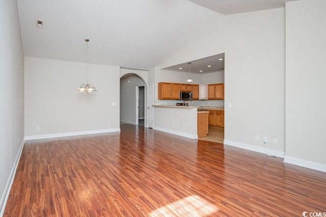 908 Wrigley Dr Unit 17-317-3G, Myrtle Beach, SC 29588 - unfurnished living room featuring arched walkways, light wood-style floors, a chandelier, and high vaulted ceiling