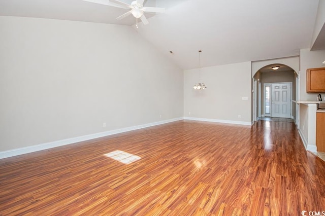 908 Wrigley Dr Unit 17-317-3G, Myrtle Beach, SC 29588 - unfurnished living room featuring light wood-style flooring, ceiling fan, lofted ceiling, arched walkways, and a chandelier