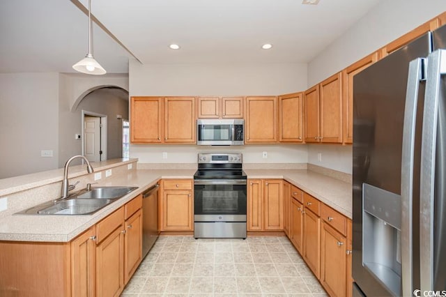 908 Wrigley Dr Unit 17-317-3G, Myrtle Beach, SC 29588 - kitchen featuring appliances with stainless steel finishes, a peninsula, light countertops, arched walkways, and hanging light fixtures
