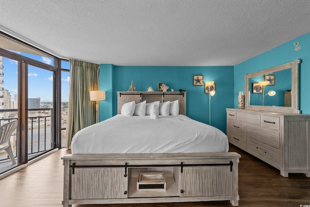 1501 Ocean Blvd S Unit 1249, Myrtle Beach, SC 29577 - bedroom featuring floor to ceiling windows, a textured ceiling, access to exterior, wood finished floors, and a city view
