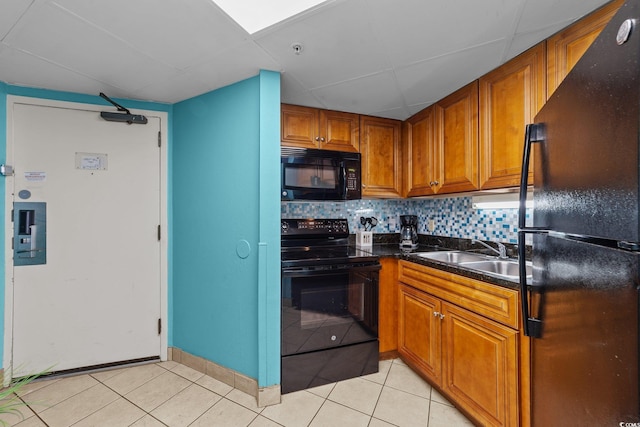 1501 Ocean Blvd S Unit 1249, Myrtle Beach, SC 29577 - kitchen with black appliances, brown cabinets, light tile patterned floors, tasteful backsplash, and a drop ceiling
