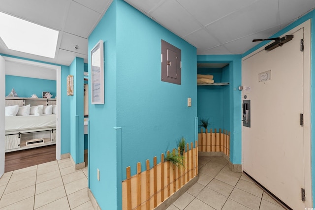 1501 Ocean Blvd S Unit 1249, Myrtle Beach, SC 29577 - hall featuring tile patterned floors, electric panel, a drop ceiling, built in shelves, and baseboards