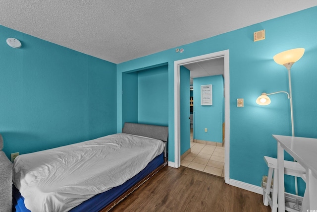 1501 Ocean Blvd S Unit 1249, Myrtle Beach, SC 29577 - bedroom featuring wood finished floors, a textured ceiling, and baseboards