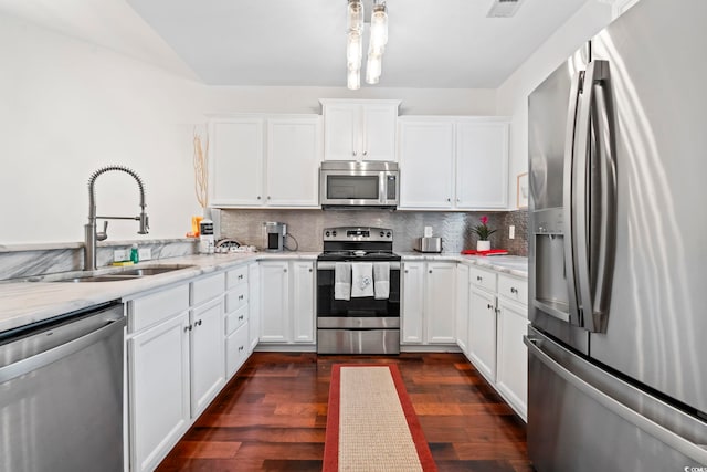 6253 Catalina Dr Unit 733, North Myrtle Beach, SC 29582 - kitchen featuring appliances with stainless steel finishes, a sink, dark wood-style floors, backsplash, and white cabinets