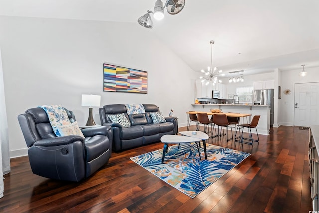 6253 Catalina Dr Unit 733, North Myrtle Beach, SC 29582 - living room featuring a chandelier, vaulted ceiling, dark wood-type flooring, and baseboards